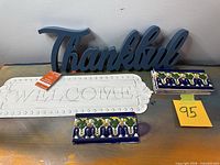 Overall view of wood signs and stacked ceramic tiles