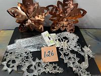 Overview of lot with tree toppers, ornaments, packaged icicle stems