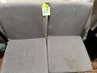 Front view of both gray upholstered chairs side by side