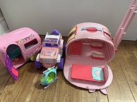 Full group showing Jeep, two campers, helicopter, bed