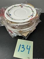 Stack of eight wrapped saucers