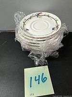 Stack of eight wrapped saucers