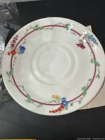 Top view single saucer showing floral pattern and condition