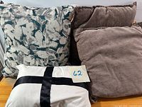 All four pillows grouped — taupe, teal/cream, white lumbar