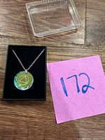 Necklace in box displaying pendant front