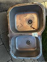 Top view of stainless double-bowl sink showing bowls, drains, no faucet holes