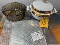 Overall view showing tureen with lid, glass bowl and cutting board