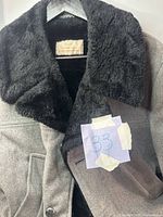 Front view showing coat color, lapel, pockets and note tag