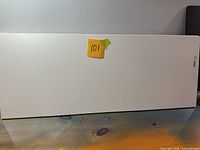 Front view of white melamine shelf panel labelled 101