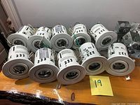 Top view of ten white recessed cans lined on table