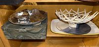Silver-tone shell platter with dip bowl on shelf