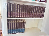Full set of encyclopaedias on two shelves showing volume count and uniform bindings