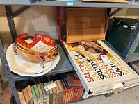 Shelf view showing Pyrex dish in cradle atop shelf and boxed Salton warming tray