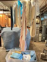 overview of linens hanging from rack with storage bin beneath