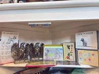 Shelf view showing eagle bookends, boxed notecards, postcards/prints