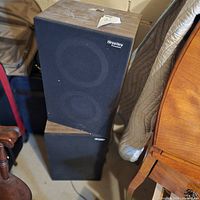 Front view showing grille, logo and both speakers