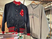 Front view of both jackets displaying Boston Red Sox patch and Super Bowl XL embroidery