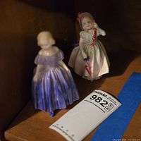 Both figurines grouped on shelf