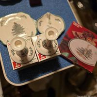 Lot overview showing dish, plate, candlesticks with boxes