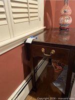 Front and side view of wooden night stand showing drawer, legs, and side slide