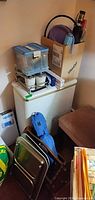 Overall lot showing hamper, plastic bin, boxed items, scale, folding trays and blue carry bag