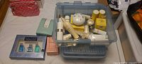 Overview of tote with assorted boxed and loose fragrance and skincare items