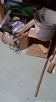 Mixed lot showing metal bucket, box of barbecue tools, hedge trimmer bar and other items