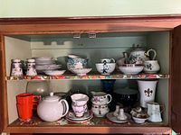 Full cabinet view showing majority of china and glass pieces