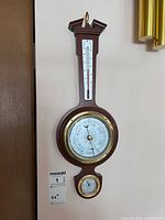 Front view of Taylor wood and brass wall weather station showing barometer, thermometer, hygrometer