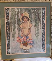 Full view of framed print showing girl with flowers and border