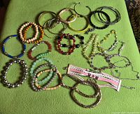 All bracelets laid out on green surface