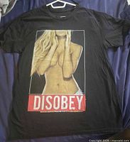Front of black T-shirt showing Disobey graphic
