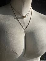 Full view of layered necklace displayed on mannequin