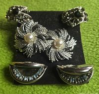 Overall view of the three pairs of clip-on earrings on black backing