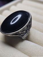 Side view showing black cabochon and floral band