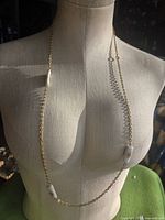 Full view of necklace on mannequin showing length and bead placement