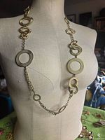 Full view of necklace on mannequin showing length and circle links