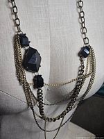 Front view showing full necklace length and layered chains