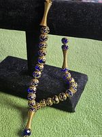 Strand draped on stand showing overall form and spacers