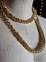 Close view of interwoven gold-tone links