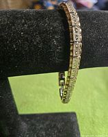 Bracelet on display stand showing link design and two-tone finish