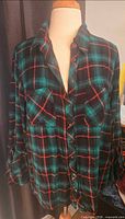 Front view of plaid flannel shirt on mannequin