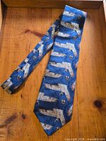 Full view of blue silk owl-pattern tie