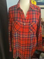 Front view of Mossimo red and navy plaid flannel shirt on mannequin