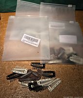 Four translucent bags each labelled 12-pack, loose clips in front showing colors and design