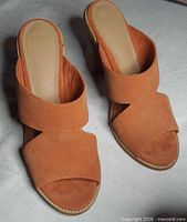 Top view of both orange UGG suede mules showing crossover straps and footbeds