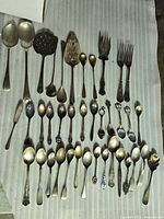 Full layout showing all spoons, serving pieces and forks