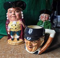 three ceramic Toby vessels grouped together