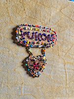 Close-up of beaded "Yukon" plaque and heart ornament on cover