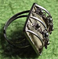 Side view showing adjustable split band and floral filigree design